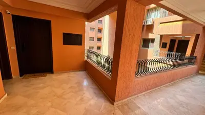 a balcony with orange walls and a black door at Cozy apartment in city center in Marrakech
