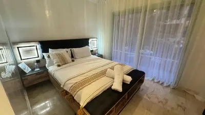 a bedroom with a large bed and a window at Cozy apartment in city center in Marrakech