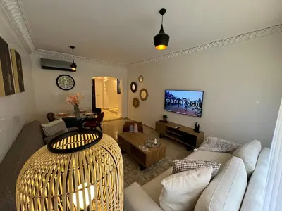 a living room with a couch and a table at Cozy apartment in city center in Marrakech