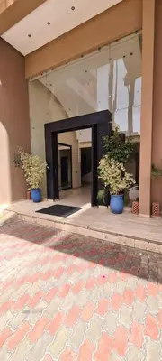 a lobby with two potted plants in a building at Appartement 2 Chambre au Coeur de gueliz Marrakech in Marrakech