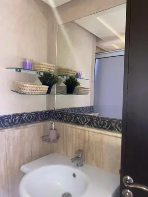 a bathroom with a sink and a mirror at Appartement 2 Chambre au Coeur de gueliz Marrakech in Marrakech
