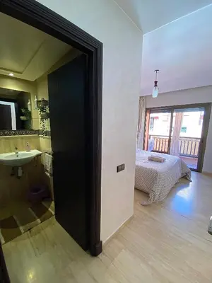 a room with a bathroom with a bed and a sink at Appartement 2 Chambre au Coeur de gueliz Marrakech in Marrakech