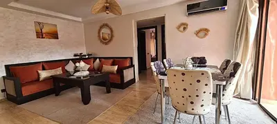 a living room with a couch and a table at Appartement 2 Chambre au Coeur de gueliz Marrakech in Marrakech
