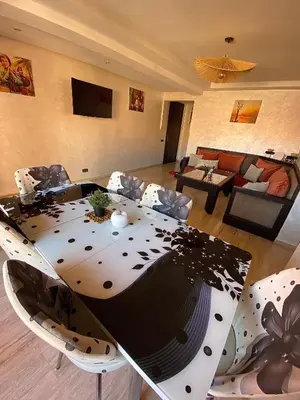 a living room with a table and a couch at Appartement 2 Chambre au Coeur de gueliz Marrakech in Marrakech