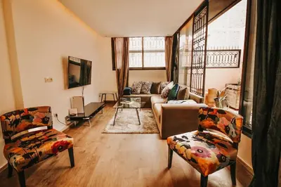 a living room with a couch and two chairs at Logement confortable et chic, Gueliz, Carre Eden in Marrakech