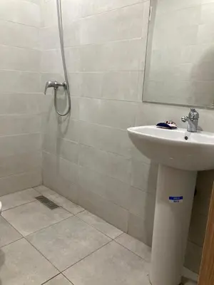a bathroom with a sink and a shower with a mirror at Magnifique appartement à Marrakech in Marrakech