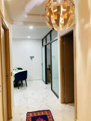 a large chandelier in a room with a table at Magnifique appartement à Marrakech in Marrakech