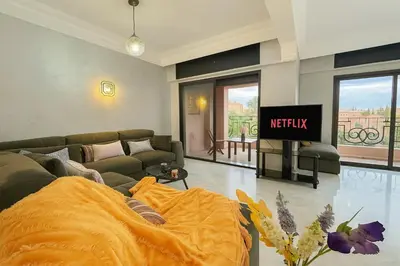 a living room with a couch and a tv at Luxurious M avenue Hivernage - next to Pestana CR7 in Marrakech