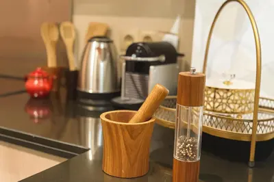 a counter top with two wooden cups and a glass at Luxurious M avenue Hivernage - next to Pestana CR7 in Marrakech