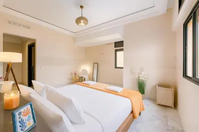 a bedroom with a large white bed with white pillows at Luxurious M avenue Hivernage - next to Pestana CR7 in Marrakech
