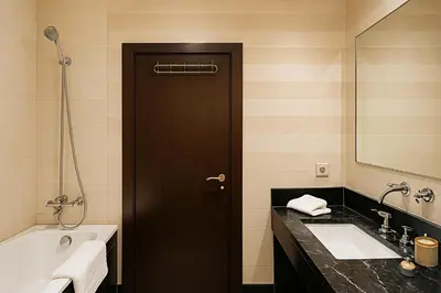 a bathroom with a black door and a tub and a sink at Luxurious M avenue Hivernage - next to Pestana CR7 in Marrakech