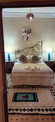 a bedroom with a bed with two pillows on it at Riad Dar Colline in Marrakech