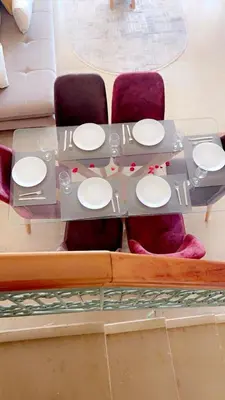 a table with white plates on it in a living room at Lot tichka villa n6 in Marrakech