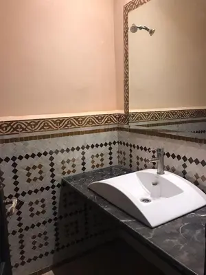 a bathroom with a sink and a mirror at Lot tichka villa n6 in Marrakech