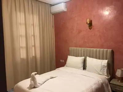 a bedroom with a bed with a white towel on it at Lot tichka villa n6 in Marrakech