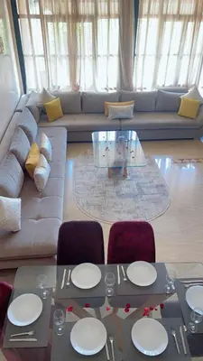 a living room with a couch and a table and chairs at Lot tichka villa n6 in Marrakech
