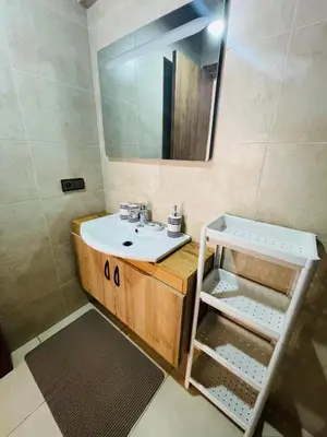 a bathroom with a sink and a mirror at Super appartement in Marrakech