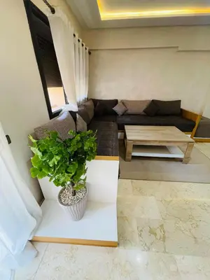 a living room with a couch and a table at Super appartement in Marrakech
