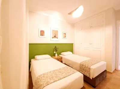 two beds in a room with green and white at old a supprimer in Marrakech