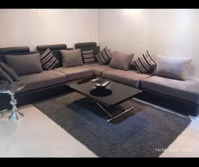a living room with a couch and a coffee table at Chic et Cosy deux chambres avec Piscine in Marrakech