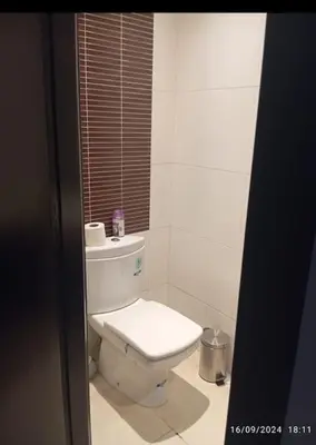 a white bathroom with a toilet and a window at Chic et Cosy deux chambres avec Piscine in Marrakech