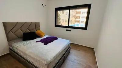 a small bedroom with a bed with a window at HIVER NAGE home in Marrakech