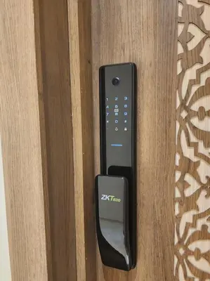 a remote control is attached to a wooden door at HIVER NAGE home in Marrakech
