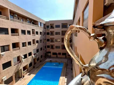 a view of an apartment building with a swimming pool at HIVER NAGE home in Marrakech