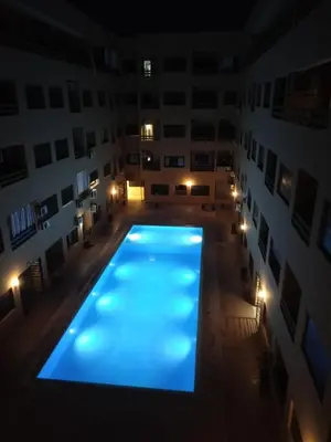 an empty swimming pool in a building at night at HIVER NAGE home in Marrakech