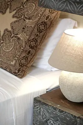 a bed with a table with a lamp next to it at Riad dar Tayri in Marrakech