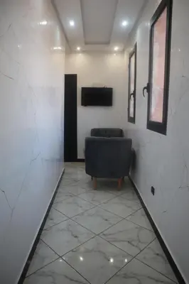 a living room with a couch and a television at Charming Medina Apartment in Marrakech