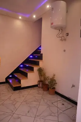 a staircase in a building with purple lights at Charming Medina Apartment in Marrakech