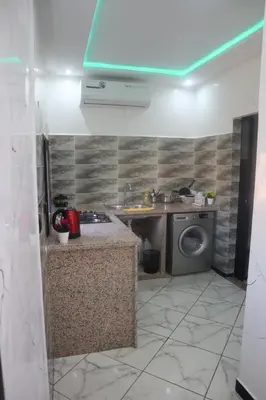 a kitchen with a sink and a washing machine at Charming Medina Apartment in Marrakech