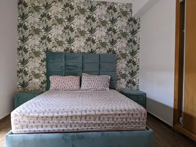 a bedroom with a bed with a patterned wall at Janat House in Marrakech
