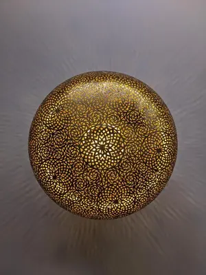 a gold bowl with a mandala pattern on it at Janat House in Marrakech