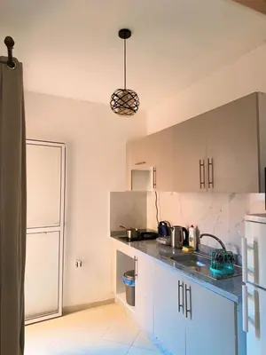 a kitchen with a sink and a counter top at Appartement Xénon in Marrakech