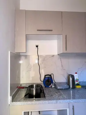 a kitchen counter with a pot on a stove at Appartement Xénon in Marrakech