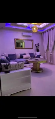 a living room with a couch and a table at Marrakech Les portes de gueliz 2 immeuble 4 appartement 29 in Marrakech