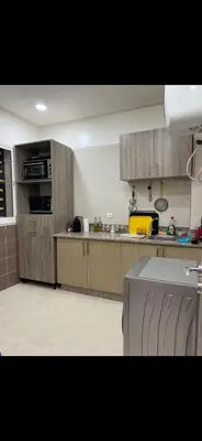 a kitchen with wooden cabinets and a counter top at Marrakech Les portes de gueliz 2 immeuble 4 appartement 29 in Marrakech
