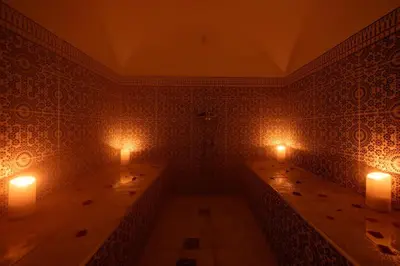 a room with two tables with candles on the wall at La Villa d'Oz pour 12 personnes Golf Amelkis in Marrakech