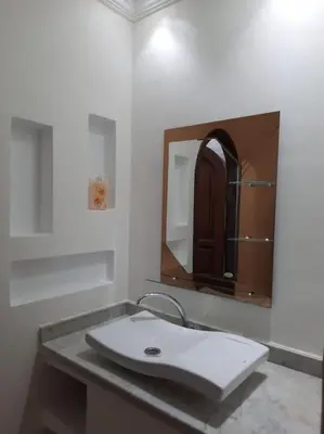 a bathroom with a sink and a mirror at Appartement avec piscine Guéliz in Marrakech