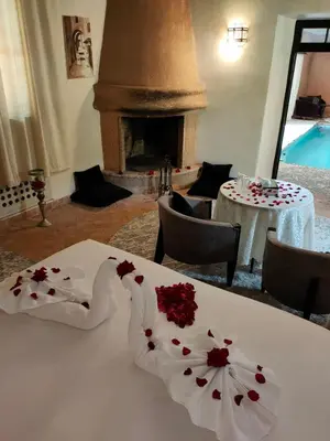 a room with a table with flowers on it at Riad shéhérazade Marrakech in Marrakech