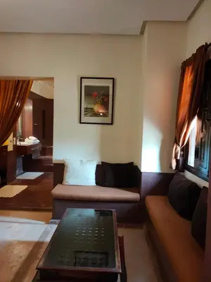 a living room with a couch and a table at Riad shéhérazade Marrakech in Marrakech