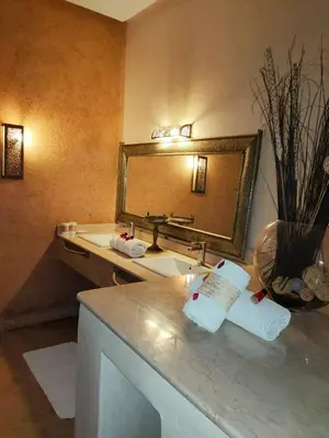 a bathroom with a sink and a mirror at Riad shéhérazade Marrakech in Marrakech