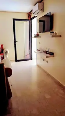 an empty room with a large door and a room with a floor at Séjour spacieux à Marrakech in Marrakech