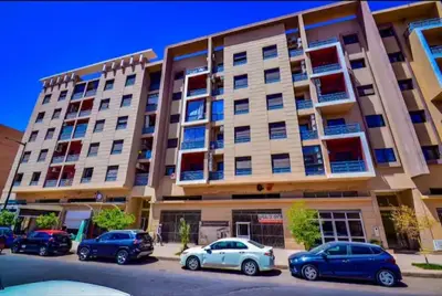 a building with cars parked in front of it at Séjour spacieux à Marrakech in Marrakech