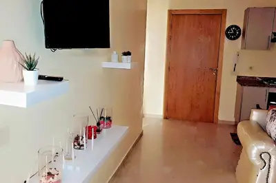 a living room with a couch and a television on a wall at Séjour spacieux à Marrakech in Marrakech