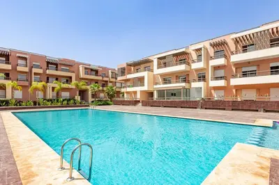 a swimming pool in front of a building at New! Appt Riad Garden, piscine & wifi & parking in Marrakech
