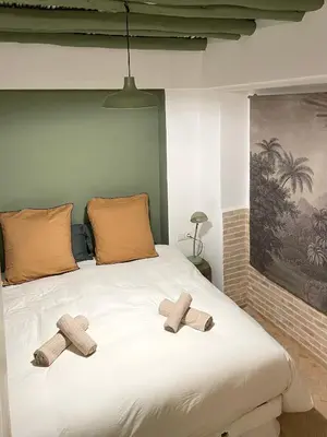 two crosses sitting on top of a bed at Riad Dardeco privé centre Medina Marrakech in Marrakech