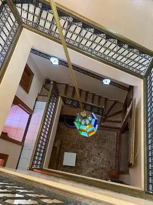 a chandelier hanging from the ceiling of a building at Riad Tichka piscine palmeraie in Marrakech